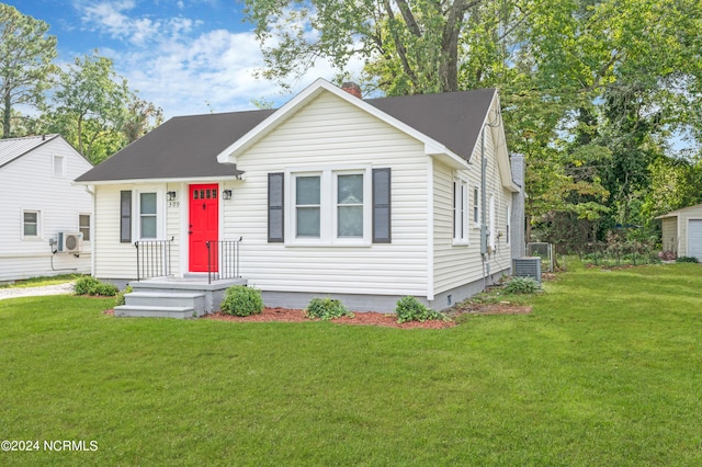 view of front facade with a chimney, cooling unit, a front lawn, and crawl space
