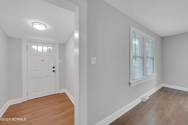 entryway featuring baseboards and wood finished floors