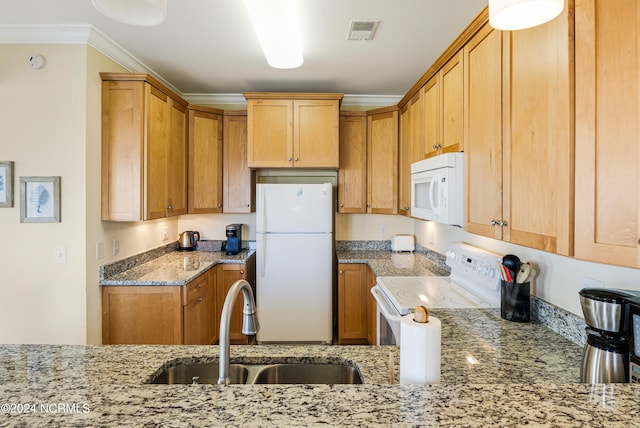 kitchen with white appliances, crown molding, light stone countertops, and sink