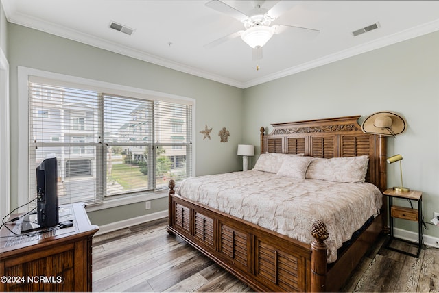 bedroom featuring ornamental molding, hardwood / wood-style flooring, and ceiling fan