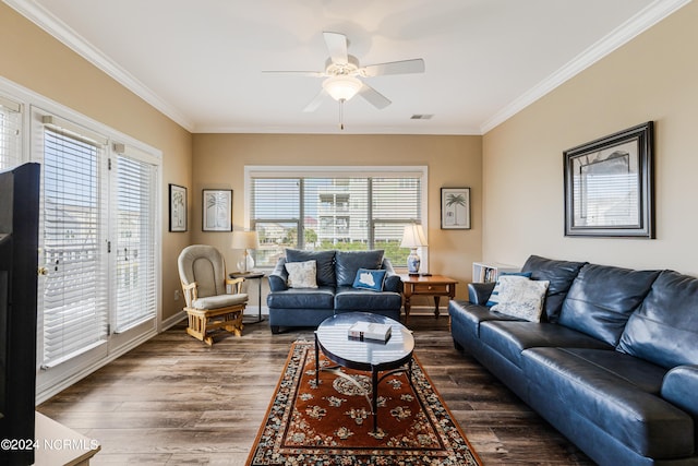 living room featuring dark wood-type flooring, ornamental molding, and plenty of natural light