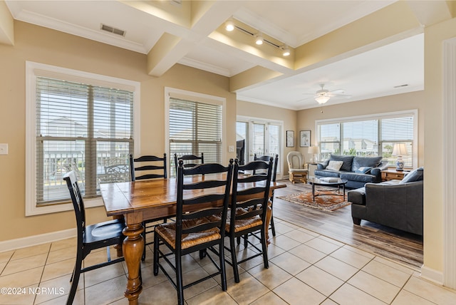 tiled dining area featuring beam ceiling, track lighting, ceiling fan, crown molding, and coffered ceiling