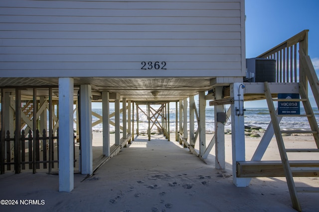 exterior space featuring a water view and a beach view