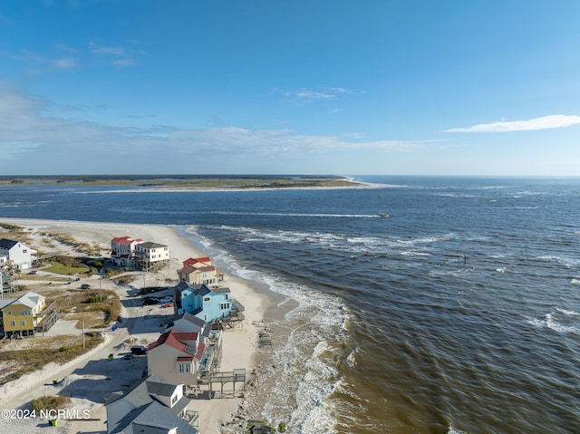 drone / aerial view featuring a water view and a beach view