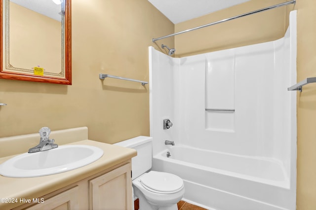 full bathroom featuring vanity, a textured ceiling, toilet, and  shower combination