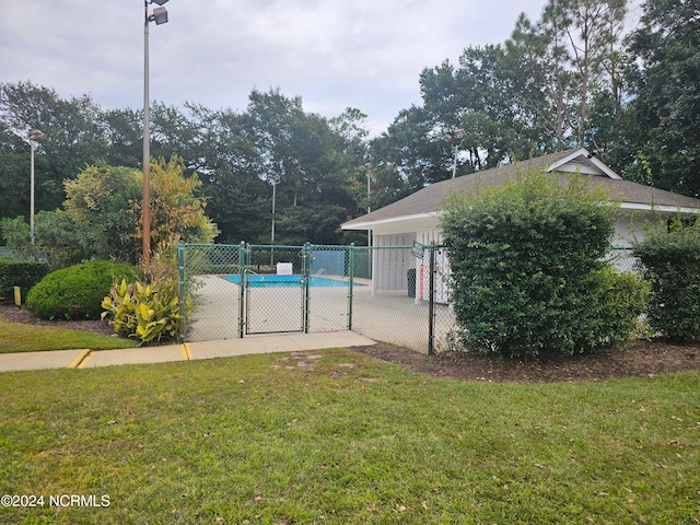 view of pool with a yard