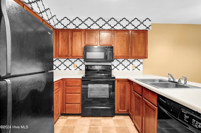 kitchen with light tile patterned flooring, sink, black appliances, and decorative backsplash