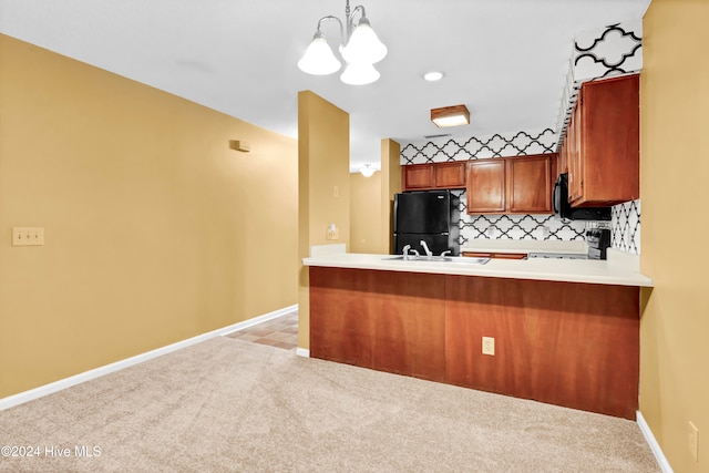 kitchen featuring light carpet, black appliances, kitchen peninsula, backsplash, and pendant lighting