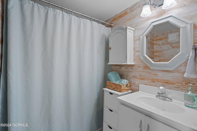 bathroom featuring vanity and a shower with shower curtain