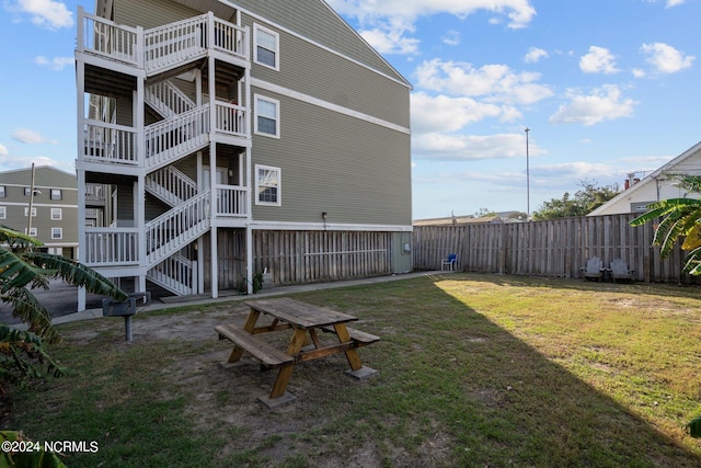 back of property with a lawn