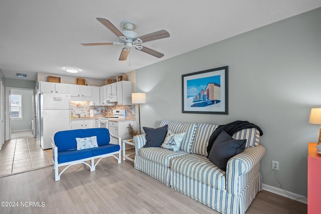 living room featuring light wood-type flooring and ceiling fan