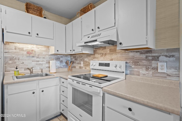 kitchen featuring tasteful backsplash, white cabinets, sink, and white electric stove