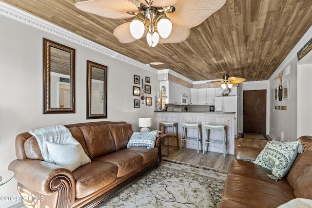 living room with a ceiling fan, crown molding, dark wood-style flooring, and wood ceiling