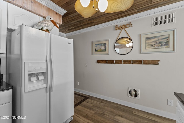 kitchen with white fridge with ice dispenser, baseboards, white cabinets, dark countertops, and dark wood-type flooring