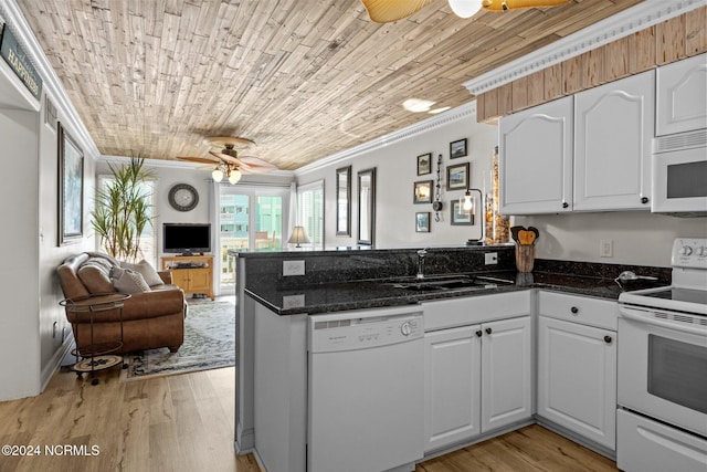 kitchen featuring white appliances, a peninsula, a ceiling fan, open floor plan, and crown molding