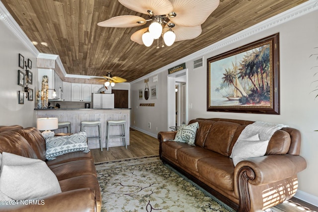 living room with crown molding, ceiling fan, wood ceiling, baseboards, and wood finished floors