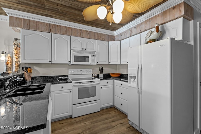 kitchen featuring white appliances, a sink, dark countertops, and white cabinets