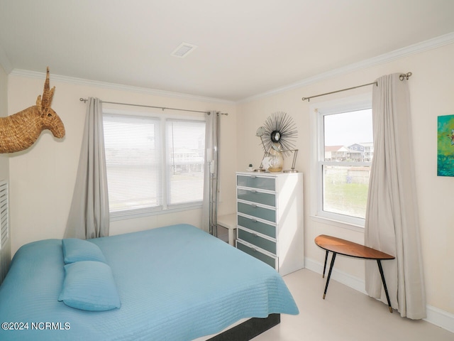 bedroom with ornamental molding and multiple windows