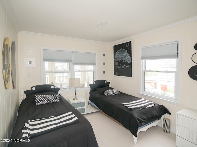 bedroom with crown molding and carpet flooring