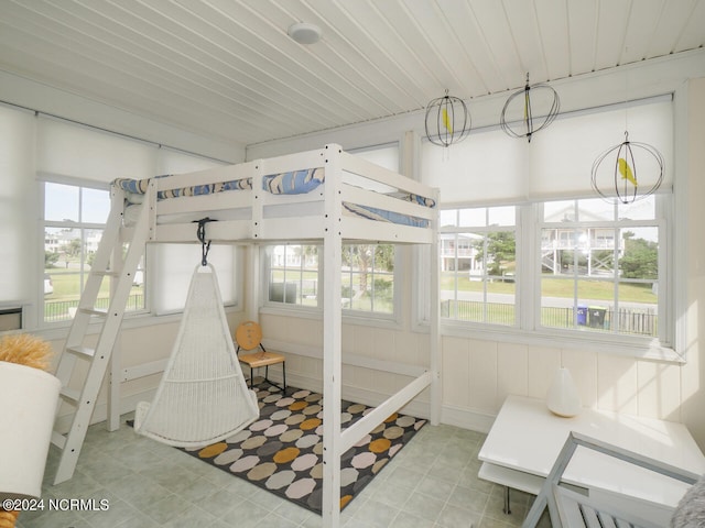 sunroom / solarium featuring wood ceiling