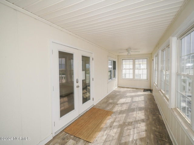 unfurnished sunroom featuring ceiling fan