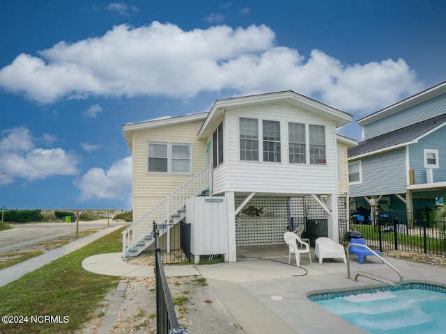 back of house featuring a fenced in pool and a patio area