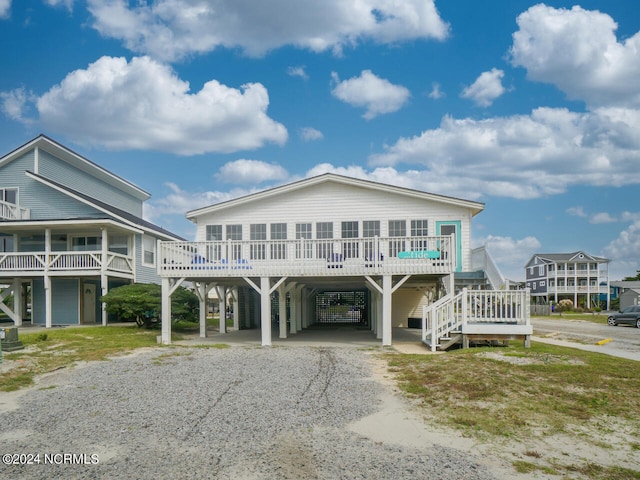 raised beach house featuring a carport