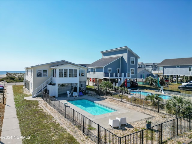 back of house featuring a patio and a fenced in pool