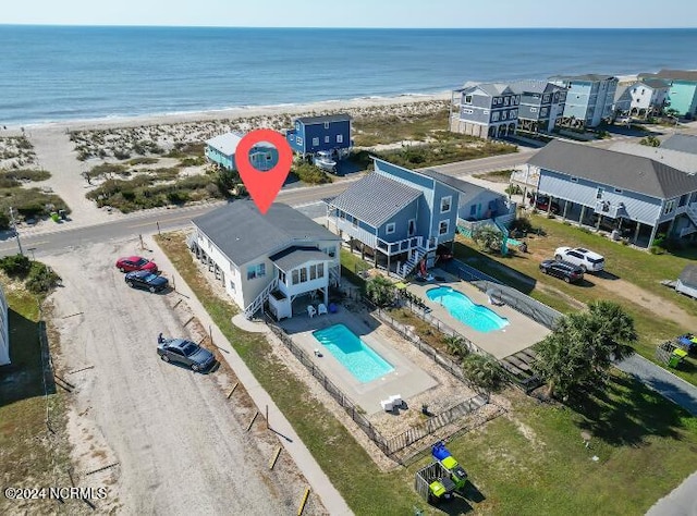 drone / aerial view with a water view and a view of the beach