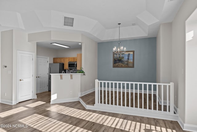 unfurnished dining area with a notable chandelier and dark hardwood / wood-style flooring