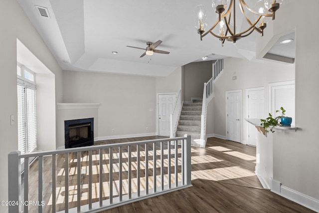 interior space featuring hardwood / wood-style floors and ceiling fan with notable chandelier