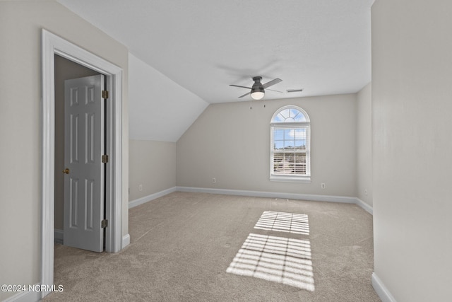 additional living space featuring light carpet, ceiling fan, and vaulted ceiling