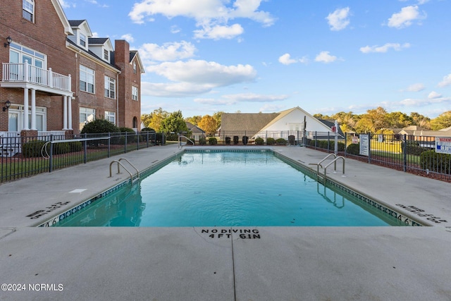 view of swimming pool featuring a patio area