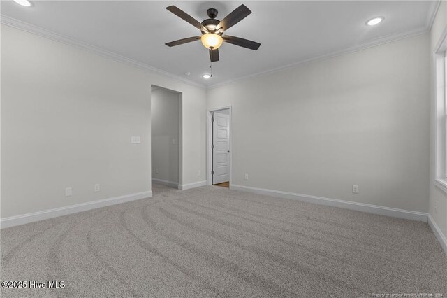 carpeted empty room featuring crown molding and ceiling fan