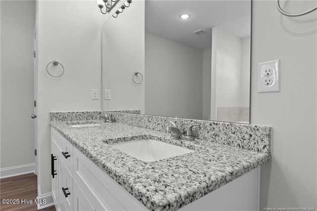 bathroom featuring vanity and hardwood / wood-style flooring