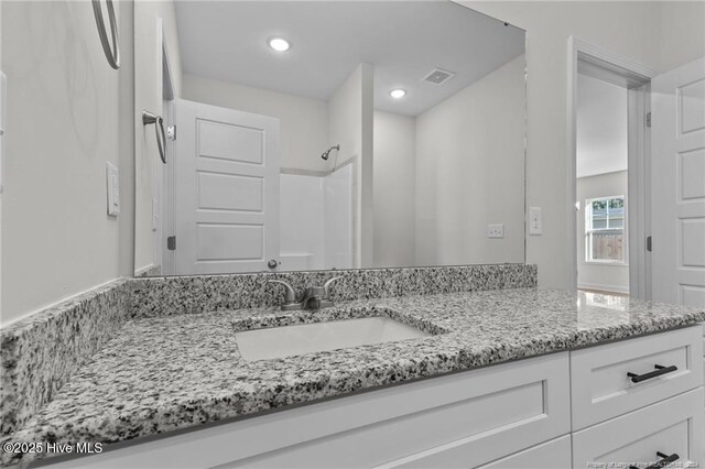 bathroom featuring vanity and walk in shower