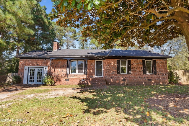 single story home with a front lawn and french doors