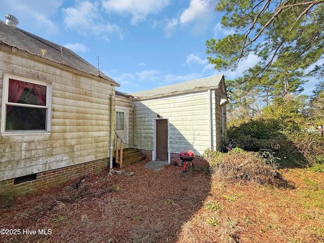 view of property exterior with entry steps and crawl space