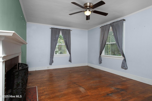 unfurnished living room featuring a fireplace, ornamental molding, a ceiling fan, wood finished floors, and baseboards