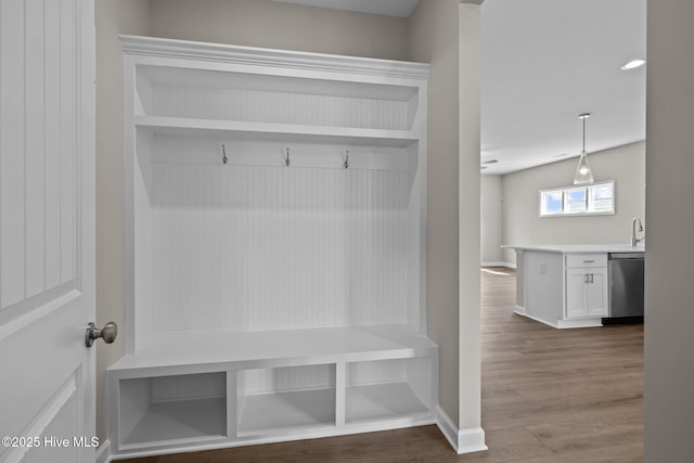 mudroom with baseboards and wood finished floors