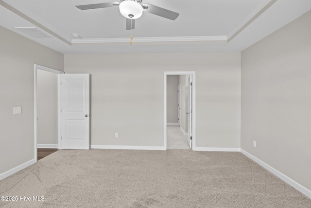 unfurnished bedroom with a raised ceiling, carpet flooring, and baseboards