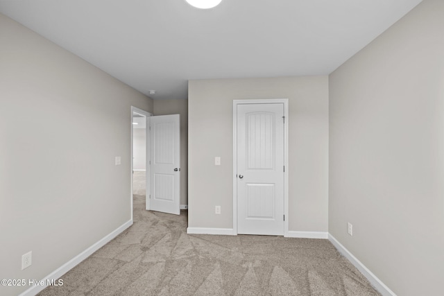 unfurnished bedroom with carpet and baseboards