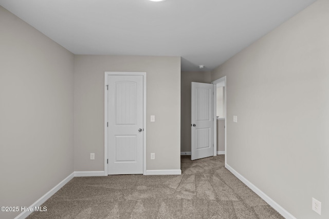 unfurnished bedroom featuring carpet flooring and baseboards