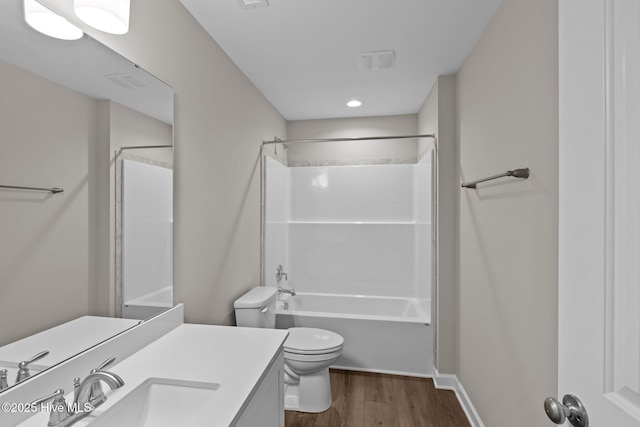 bathroom featuring shower / washtub combination, vanity, toilet, and wood finished floors