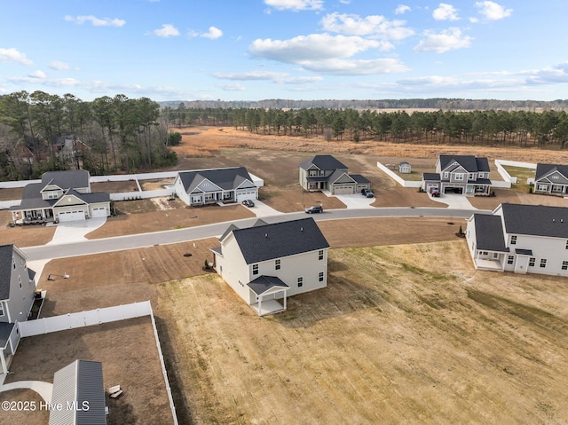 birds eye view of property with a residential view and a view of trees