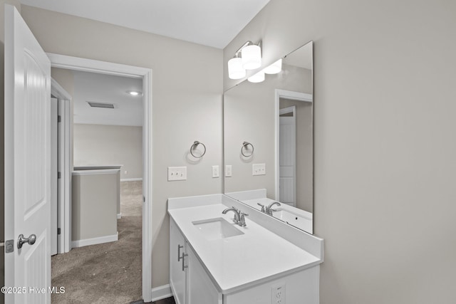 bathroom with baseboards, visible vents, and vanity