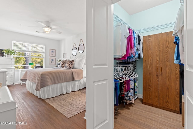 bedroom with ceiling fan and light hardwood / wood-style flooring