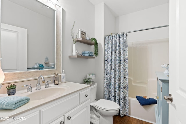 full bathroom featuring shower / tub combo with curtain, hardwood / wood-style flooring, vanity, and toilet