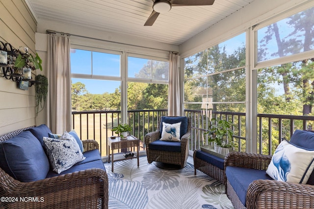 sunroom featuring ceiling fan, a wealth of natural light, and wood ceiling