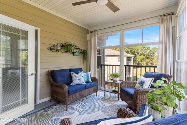 sunroom featuring ceiling fan, wood ceiling, and a wealth of natural light